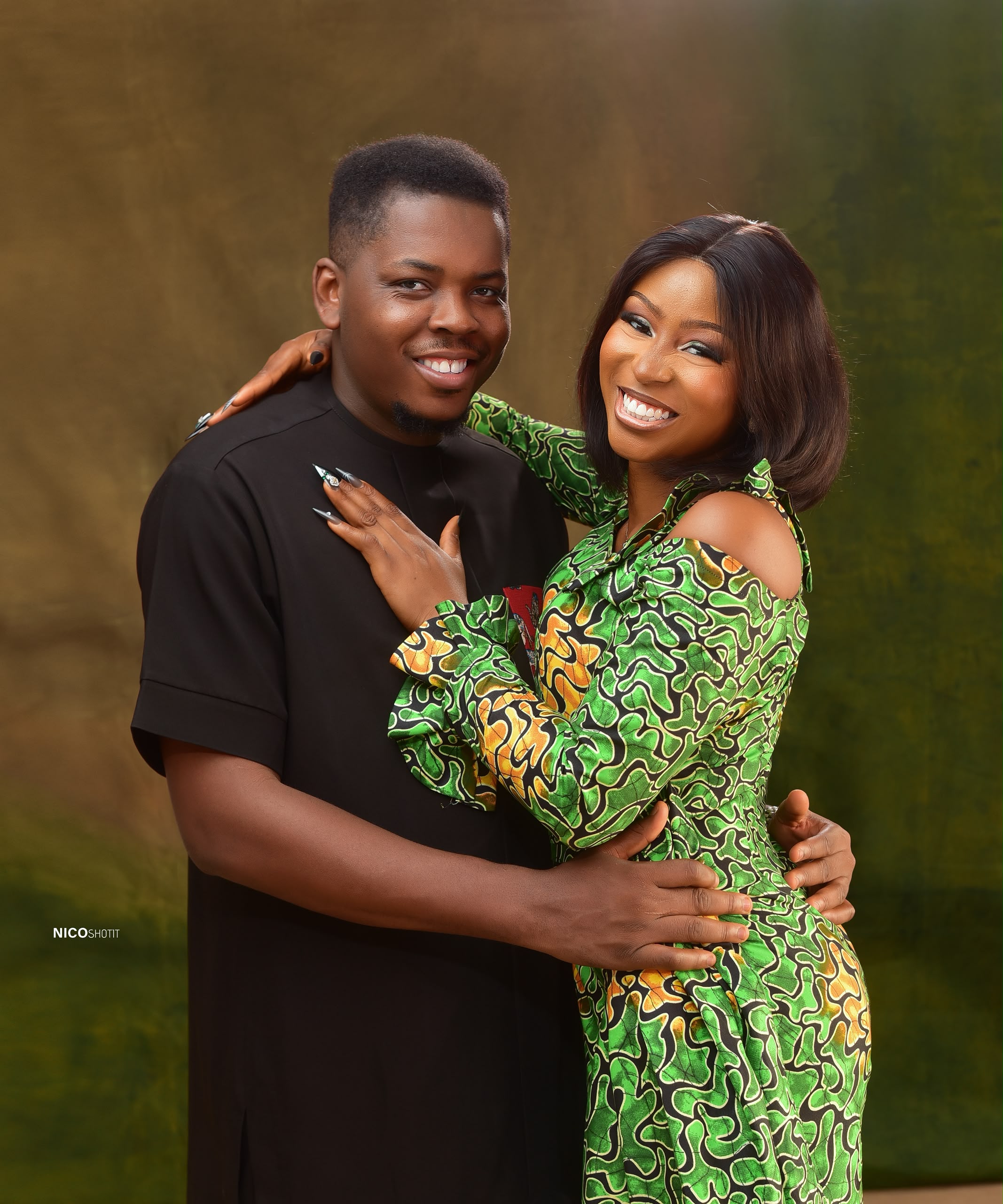 Mmachukwu and Chisom in matching Ankara outfits embracing warmly