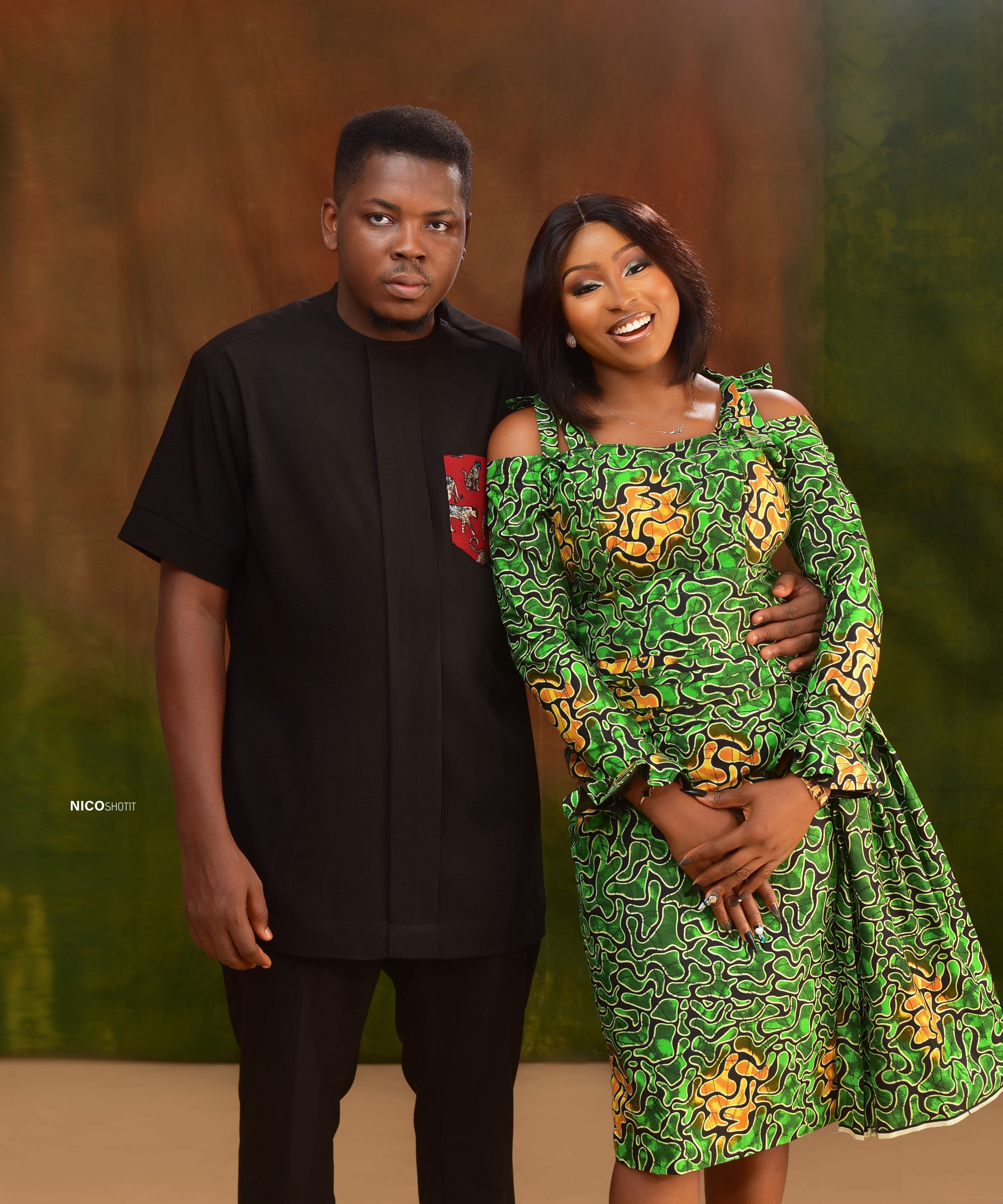 Chisom in black and Mmachukwu in radiant emerald Ankara smiling together